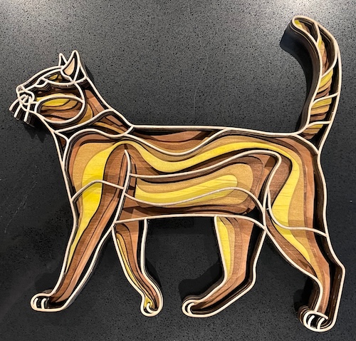 Laser-Cut Catitude Laser Cutting Project - This unique layered cat artwork is a perfect laser cutting project for animal lovers and craft enthusiasts. With downloadable design files and tips, you can create this elegant cat with intricate layers and a flowing pattern of wood tones. Display it as wall art or gift it to a friend who loves cats!