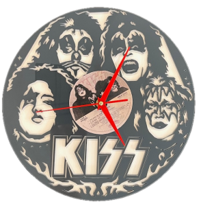 This image shows a circular wall clock inspired by the rock band KISS. The clock face features the black-and-white, laser-cut faces of the band members in their iconic makeup. The KISS logo is prominently displayed at the bottom, and the center holds a real vinyl record with visible text and a small photo of the band. Bright red clock hands contrast the monochromatic design, making this a striking homage to the legendary rock group. Common Laser Cutting Mistakes