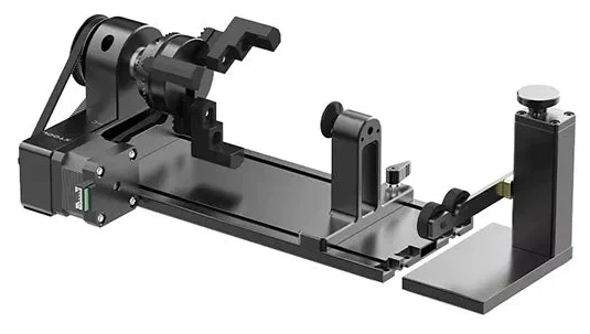 This image shows an xTool RA2 rotary attachment designed for laser engraving cylindrical objects. The device is a compact, adjustable piece of equipment with a metal frame, featuring a rotating chuck that can securely hold round items like bottles, glasses, or other cylindrical objects. The setup includes sturdy grips and adjustable components to accommodate various object sizes. This tool allows users to engrave precise designs on curved surfaces, enhancing the versatility of a laser cutting machine.