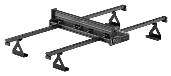 This image displays a black, rectangular riser base designed to elevate laser cutting and engraving machines. The riser has a hollow center, allowing users to work with thicker materials or attach accessories such as rotary tools. It offers a solid, stable platform, enhancing the laser’s versatility by creating extra space for larger projects or specialized attachments, making it ideal for users looking to expand their laser engraving capabilities.